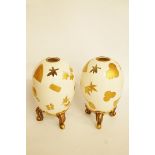 A pair of Royal Worcester aesthetic movement porcelain vases, of pierced egg form, each on three
