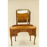 A mid 20th century walnut kidney shaped dressing table with triple mirrored back, H 157cm overall,