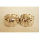 A pair of silver napkin rings, Mappin and Webb, Birmingham 1937, of panel form, monogrammed, 60 g