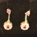 A pair of 9ct gold ruby and diamond drop earrings, the ruby and single cut diamond cluster to a