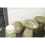 A pair of 20th century saddlestones and one other