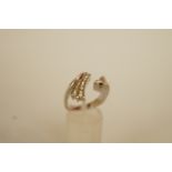 A diamond dress ring, set with a trilliant cut and thirteen channel set brilliant cut diamonds, to