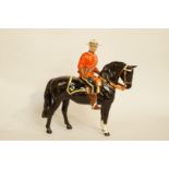 A Beswick Canadian Mountie on a dark bay horse, printed marks in black 1375, H 21cm