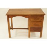 A mid 20th century child's mahogany desk with three drawers, H 75.5cm W 103.5cm D 59cm