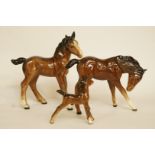 A Beswick figure of a bay foal, H 11.5cm and two other Beswick foals, all with printed marks in