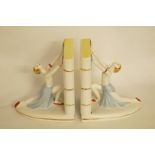 A pair of Art Deco style book ends each with a stylised female figure holding a book, H 16cm,