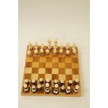 A 20th century chess set in parquetry chess set box, 44cm x 45cm