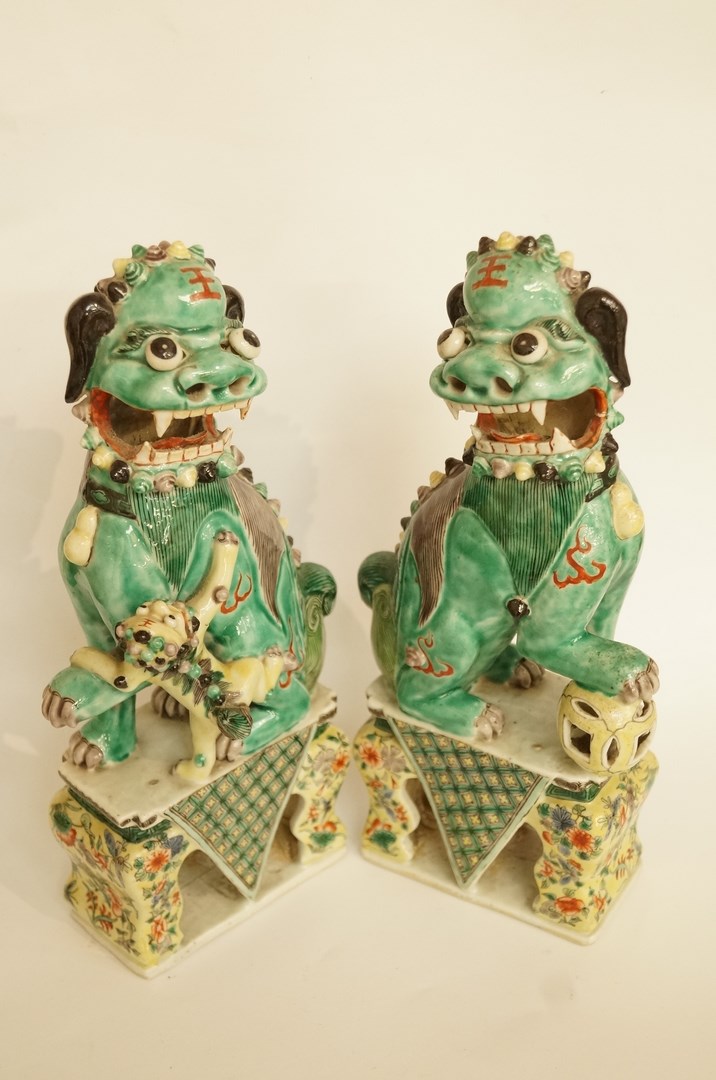 A pair of Chinese porcelain figures of Guardian dogs, H 30cm