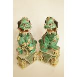 A pair of Chinese porcelain figures of Guardian dogs, H 30cm