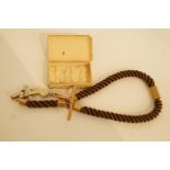 A memorial hair watch chain with 9 carat gold fittings, attached is an engraved working miniature