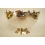 A silver fruit bowl, Baker Brothers, Chester 1912, the shaped and moulded rim to a plain bowl on a