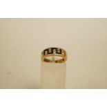 A calibre onyx and diamond 9 carat gold ring, the calibre stones to a Greek key pattern with single