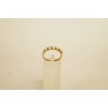 A five stone 9 carat gold ring, finger size O, 2.4 g gross