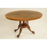 A walnut oval marquetry tilt top table with central turned and tapered pedestal on three splayed