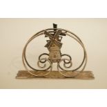 A Dutch silver plated table napkin holder, with a windmill motif, 10 cm long