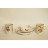 A 19th century Meissen tea cup and saucer painted with European flower sprays within iron red rims,