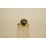 A diamond and sapphire cluster 18 carat gold ring, the thirteen brilliant cuts totalling