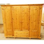 A large three section pine wardrobe with four doors and four drawers, H 184.5cm W 199cm D 58cm