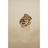 An aquamarine and diamond 9 carat gold cluster ring, of flower head design, finger size P; with two