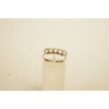 A five stone ring, the white mount stamped '585', finger size O1/2, 2.6 g gross