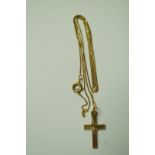 A 9ct gold cross pendant on a chain; 1.5 g gross