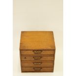 A mid 20th century small oak chest of four drawers, H 31cm W 31.5cm D 26cm