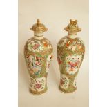 A pair of 19th century canton enamel vases and covers, with gilded dog of Fo finials, H 32.5cm