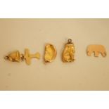 Five gold charms, comprising a cat; a bean; a bell; an elephant and a plane; 2.8 grams total
