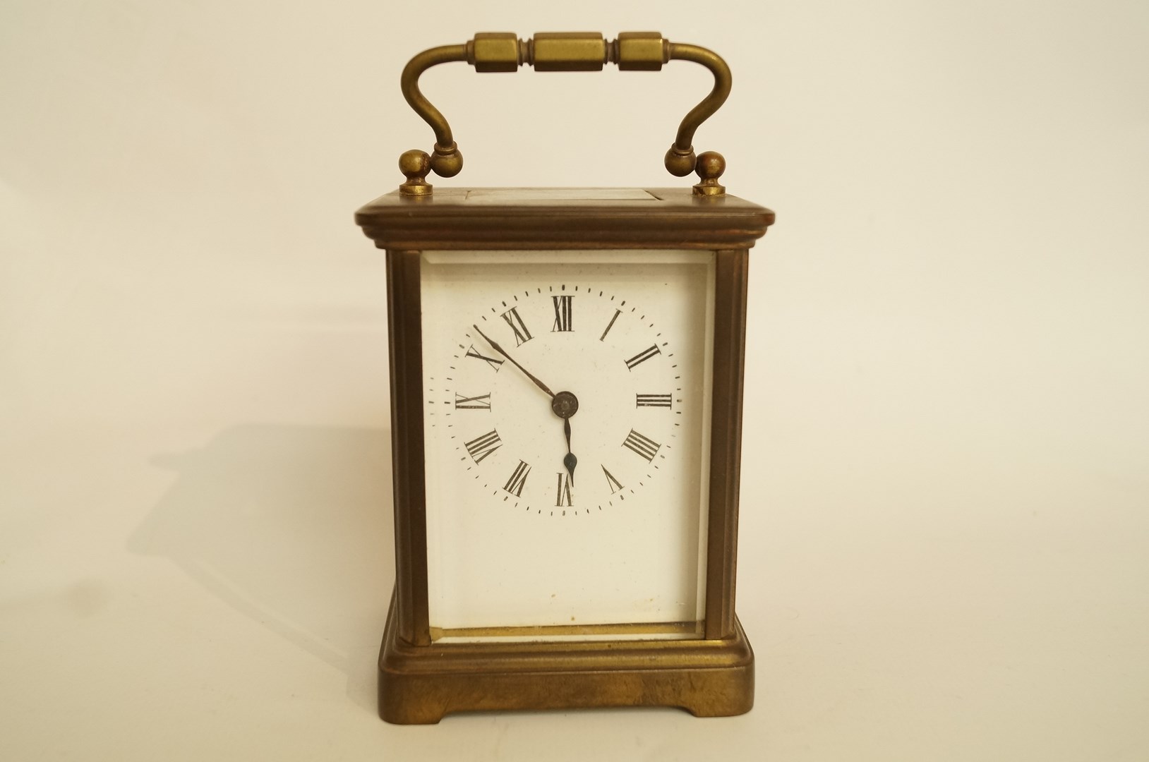 A brass carriage clock with white enamel dial, and key, H 14.5cm overall