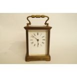 A brass carriage clock with white enamel dial, and key, H 14.5cm overall