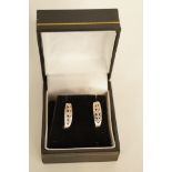 A pair of five stone pink diamond earrings, the graduated stones set in 9 carat white gold, cased