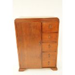 A mid 20th century oak compendium, with one cupboard door and five drawers, H 128cm W 90.5cm D 43cm