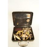 A small quantity of jewellery, including a silver locket, brooches and other items, housed in a