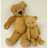 A large 1940's straw filled teddy bear having glass eyes, stitched nose,