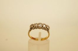 A five stone diamond ring, stamped '18ct' and 'Plat', the graduated old cut stones illusion set,