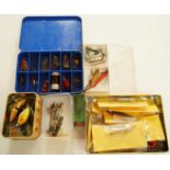 A box of assorted lures including Mepps,