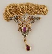 A diamond and ruby pendant brooch, stamped '750', in the Edwardian style,