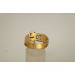 A late Victorian 18 carat gold two stone diamond set buckle ring, Birmingham 1881,