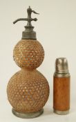 A French Soda syphon of double gourd form and caned cover and a leather covered flask
