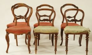 A pair of Victorian mahogany campaign balloon back chairs with stuff over seats and turned legs by