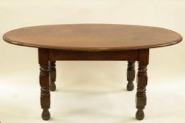 A 20th century oval oak dining table with turned and block legs, 76.
