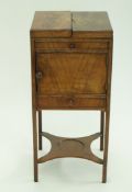 A George III mahogany wash stand, with opening top above one cupboard door and one frieze drawer ,