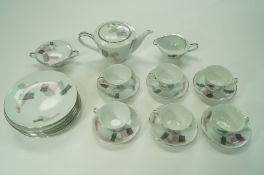A Japanese porcelain  early 1970s tea service decorated in pink, grey and black with silvered rims,