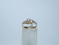 A two stone diamond 18ct gold crossover ring, the brilliant cuts, totalling approximately 0.