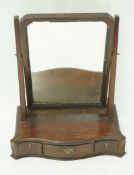 A mahogany swing frame mirror, with serpentine box base enclosing three drawers, 56cm high,