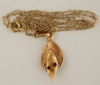 A 9ct gold two stone ruby leaf pendant and chain, 2.