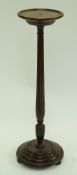 A mahogany jardinière stand with reeded tapering support, stepped round base and bun feet,