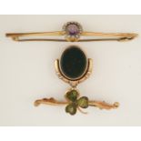 A bar brooch with a clover leaf motif set with connemara marble;