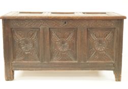 A mid 17th century oak coffer with carved triple panelled front, 119cm wide, 65cm high,