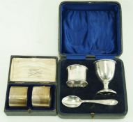 A cased silver christening set, comprising an egg cup, a napkin ring and a spoon,